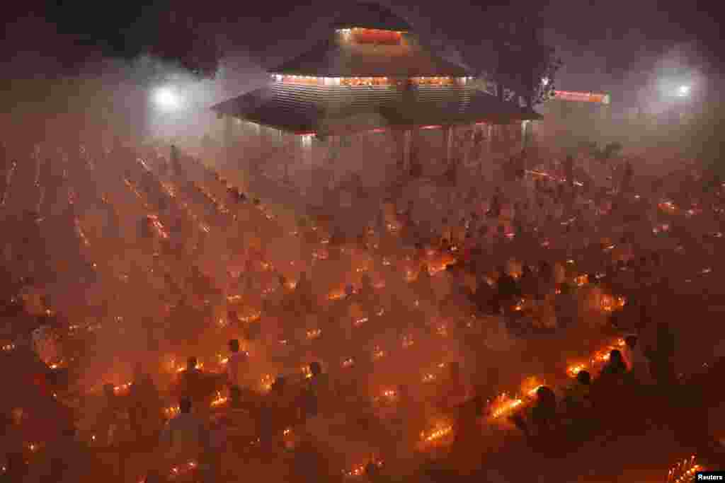 Hindu devotees pray to Lokenath Brahmachari, a Hindu saint and philosopher, as they observe the Rakher Upobash festival at a temple in Narayanganj, Bangladesh.