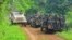 FILE - Congolese soldiers and U.N. forces patrol the area of an attack by suspected Allied Democratic Forces near Oicha, 30 kms from Beni, Democratic Republic of Congo, 7.23.2021