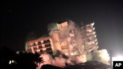 The remaining structure of the Champlain Towers South condo building is demolished more than a week after it partially collapsed, July 4, 2021, in Surfside, Fla. 