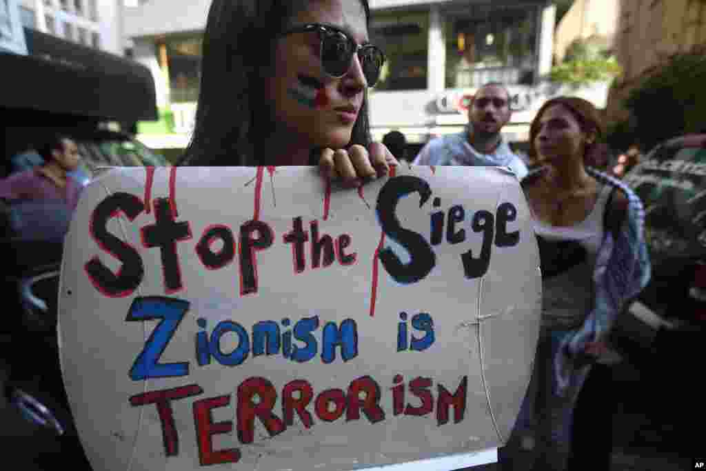 A Lebanese student from American University holds a placard during a protest against the Israeli offensive on Gaza, in Beirut, July 14, 2014.