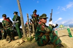 FILE - A TNLA (Ta'ang National Liberation Army) soldier looks on, during the 51st anniversary of the Ta'ang National Resistance Day at Homain, Nansan township in the northern Shan state, Myanmar, Jan. 12, 2014.