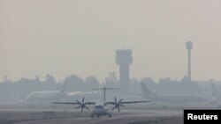 A passenger plane is set to take off at Mexico City's international airport as authorities declared an environmental emergency for Mexico City as smoke from wildfires pushed pollution to harmful levels in Mexico City, May 14.