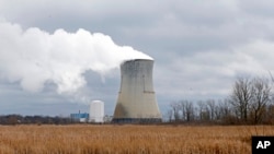 FILE – Steam rises from the cooling tower of FirstEnergy Corp.'s Davis-Besse Nuclear Power Station in Oak Harbor, Ohio, April 4, 2017.