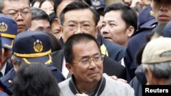 Taiwan's jailed former President Chen Shui-bian leaves a funeral house after paying his respects to his late mother-in-law in Tainan, southern Taiwan, January 6, 2012.