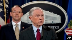 FILE - Attorney General Jeff Sessions accompanied by Deputy Attorney General Rod Rosenstein, left, speaks at a news conference.