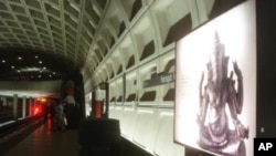 On the metro platform, in Washington DC, a billboard highlights the “Gods of Angkor” exhibit. 