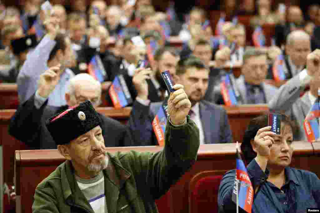 Participants vote during the first session of the new local parliament of the self-proclaimed Donetsk People&#39;s Republic in Donetsk, eastern Ukraine.