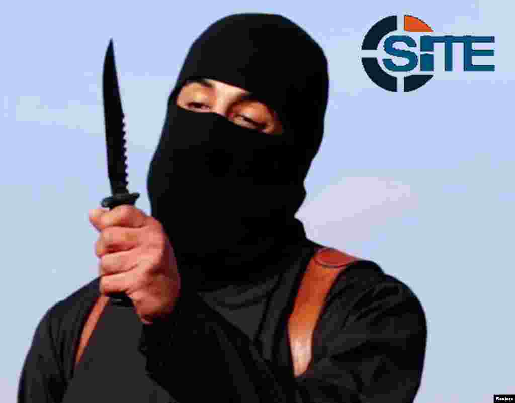 A masked, black-clad militant, who has been identified by The Washington Post newspaper as a Briton named Mohammed Emwazi, brandishes a knife in this still image from a 2014 video obtained from the SITE Intel Group, Feb. 26, 2015.