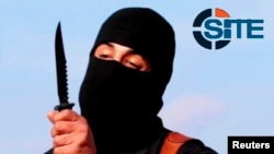 FILE - A masked, black-clad militant known as "Jihadi John" brandishes a knife in this still image from a 2014 video obtained from SITE Intel Group Feb. 26, 2015. 