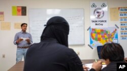 FILE - Afghan refugees take a class at the Fort McCoy, Wis., U.S. Army base, Sept. 30, 2021. The fort is one of eight military installations across the country that are temporarily housing tens of thousands of Afghan refugees. 