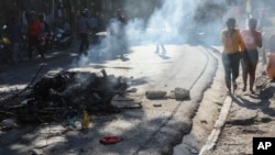 Los cadáveres de presuntos miembros de pandillas que fueron quemados por los residentes, se encuentran en una pila en medio de una carretera en el barrio de Pétion-Ville de Puerto Príncipe, Haití, martes 19 de noviembre de 2024. 