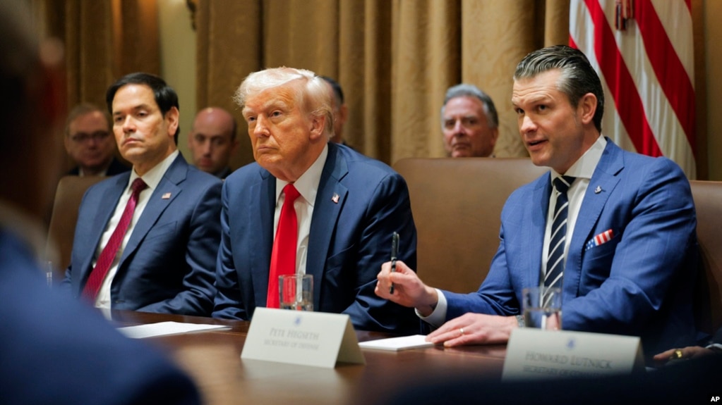 President Donald Trump listens during a Cabinet meeting at the White House in Washington, Feb. 26, 2025, as Secretary of State Marco Rubio and Defense Secretary Pete Hegseth listen.