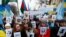 Участники митинга в Киеве держат в руках портреты жертв российской аннексии Крыма, февраль 2017 года