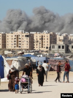 Smoke rises following an Israeli strike on a residential building in Khan Younis, in the southern Gaza Strip, on Aug. 16, 2024.