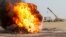 Flames and smoke rise from oil wells inside the Bai Hassan oil field, which was attacked by militants, close to the northern Iraqi city of Kirkuk, Iraq, May 5, 2021. 