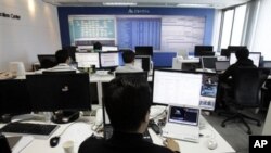 Technicians of AhnLab Inc. work against online attacks at the company's Security Operation Center in Seoul, South Korea, March 4, 2011