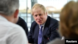 FILE - Britain's Prime Minister Boris Johnson chairs a cabinet meeting at the National Glass Center at the University of Sunderland, in Sunderland, Britain, Jan. 31, 2020.
