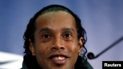 Brazilian national soccer team player Ronaldinho smiles during a news conference at Wembley stadium in London February 5, 2013. Brazil are set to play England in an international friendly soccer match on Wednesday. REUTERS/Stefan Wermuth (BRITAIN - Tags: