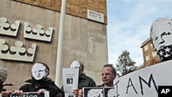 Supporters of WikiLeaks founder Julian Assange, some wearing masks depicting him and holding placards, participate at a demonstration outside the Swedish Embassy in London, 13 Dec 2010