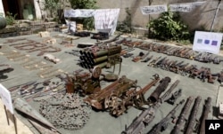 Pakistan army display confiscated ammunition, reportedly from militants Miranshah, after driving out militants from Pakistan's tribal region of North Waziristan along the Afghanistan border, July 9, 2014.