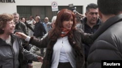 Argentina's President Cristina Fernandez de Kirchner greets supporters outside a polling station in Rio Gallegos, Argentina, Oct. 25, 2015. 