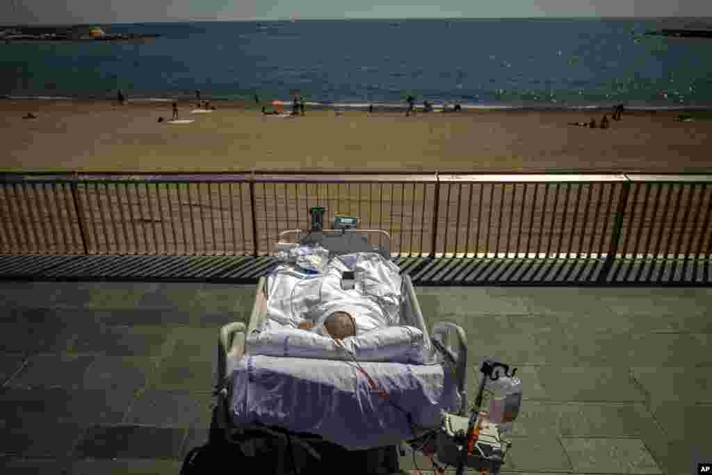 Francisco Espana, 60, looks at the Mediterranean sea from a promenade next to the Hospital del Mar in Barcelona, Spain. Francisco spent 52 days in the Intensive Care Unit at the hospital due to coronavirus.