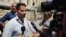 Lebanese father Ali al-Amin speaks to journalists after dropping charges against his estranged wife and an Australian TV crew for attempting to kidnap their children, in front of the courthouse, in the Beirut southeastern suburb of Baabda, Lebanon, Wednes