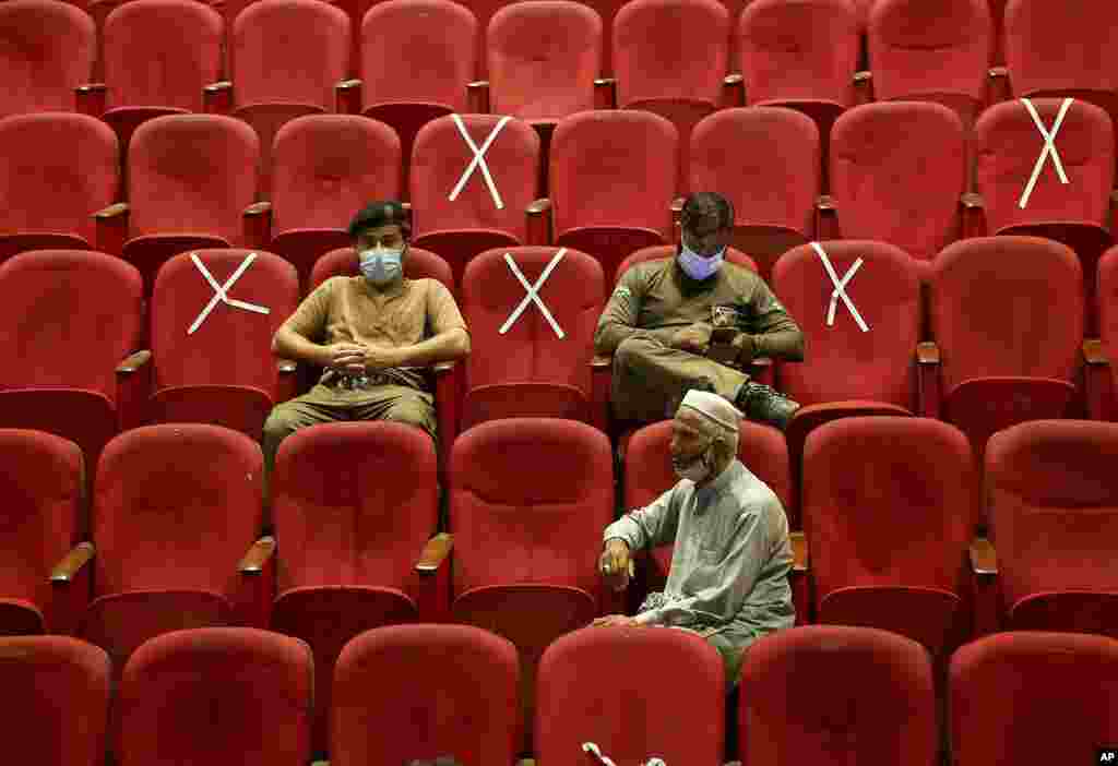 Government employees wait their turn to receive the Convidecia COVID-19 vaccine at a vaccination center in Nishtar hall, in Peshawar, Pakistan.