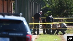 Members of law enforcement investigate an area at Townville Elementary School in Townville, South Carolina, after a shooting, Sept. 28, 2016. 