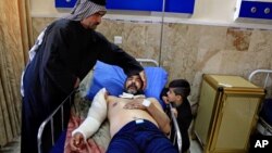 A victim of a bombing attack receives treatment at the Imam Ali Hospital in Sadr City, Baghdad, Iraq, Feb. 29, 2016.