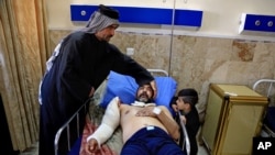 A victim of a bombing attack receives treatment at the Imam Ali Hospital in Sadr City, Baghdad, Iraq, Feb. 29, 2016.