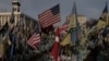 U.S., Ukrainian and other flags are seen at a makeshift memorial for fallen Ukrainian and foreign fighters on Independence Square in Kyiv on March 4, 2025, amid the Russian invasion of Ukraine.