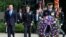 US President Donald Trump (L) is escorted for a ceremony to lay a wreath at the Tomb of the Unknown Soldier at Arlington National Cemetery, as part of Memorial Day observance, Arlington, Virginia, May 29, 2017. 