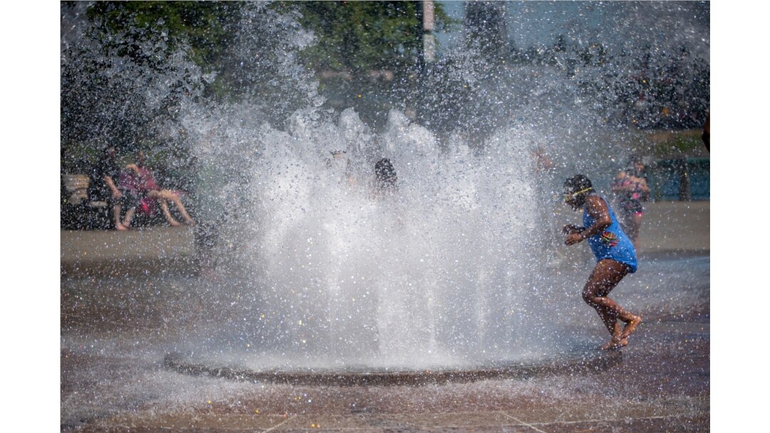 While Portland reached a record temperature of over 110 degrees, June 27, 2021 people gathered at Salmon Street Springs water fountain in Portland to cool off. (Mark Graves/The Oregonian via AP)