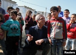 United Nations High Commissioner for Refugees (UNHCR) Filippo Grandi meets with Syrian refugee children, during his visit to an informal settlement in Mohammara, Akkar Governorate, Lebanon, March 9, 2019.