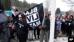 FILE - Students at the Montpelier High School in Montpelier, Vt., raise a Black Lives Matter flag on Feb. 1, 2018, as part of a series of activities to discuss racism.