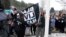 FILE - Students at the Montpelier High School in Montpelier, Vt., raise a Black Lives Matter flag on Feb. 1, 2018, as part of a series of activities to discuss racism.