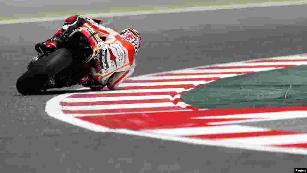 Honda MotoGP rider Marc Marquez of Spain takes a curve during the second free practice at the Catalunya Grand Prix in Montmelo, near Barcelona.
