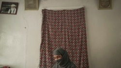 Najieh, who grew up as a bacha posh, sits at her house during an interview, in Kabul, Afghanistan, Oct. 1, 2021.