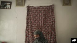 Najieh, who grew up as a bacha posh, sits at her house during an interview, in Kabul, Afghanistan, Oct. 1, 2021.