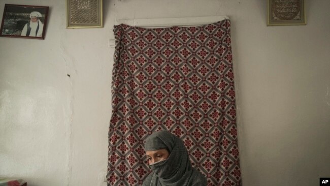 Najieh, who grew up as a bacha posh, sits at her house during an interview, in Kabul, Afghanistan, Oct. 1, 2021.