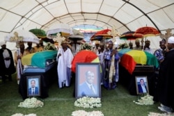 The coffins of Amhara Regional President Ambachew Mekonnen and two other officials who were killed in an attack are seen during a funeral ceremony in the town of Bahir Dar, Amhara region, Ethiopia, June 26, 2019.