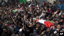 Palestinians carry bodies of Ahmed Abu al-Aish, 28, and Laith Manasrah, 21, during their funeral at Qalandia refugee camp on outskirts of West Bank city of Ramallah, Nov. 16, 2015. 
