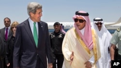 U.S. Secretary of State John Kerry, left, is greeted by Saudi Foreign Minister Prince Saud al-Faisal upon arrival in Jeddah, Saudi Arabia, June 25, 2013.