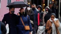 Shoppers in the crowd wear face masks against the ongoing pandemic on Oxford Street in London, Dec. 24, 2021.