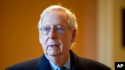 Senate Minority Leader Mitch McConnell, R-Ky., speaks to a reporter at the Capitol in Washington, Jan. 19, 2022.