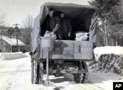 This circa 1940s photo released by the New Hampshire Department of Transportation archives shows salt being applied for anti-icing on a New Hampshire roadway.
