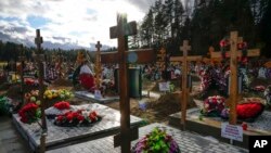 Graves and crosses are seen at the Yastrebkovskoe cemetery, which serves as one of the burial grounds for those who died of COVID-19, outside Moscow, Russia.