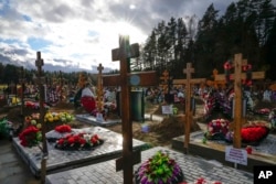 Graves and crosses are seen at the Yastrebkovskoe cemetery, which serves as one of the burial grounds for those who died of COVID-19, outside Moscow, Russia.