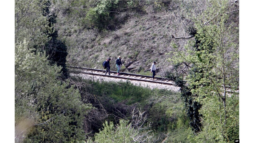 Near the site where 14 migrants were killed by a train, others walk along tracks north of the central Macedonian town of Veles, April 24, 2015.